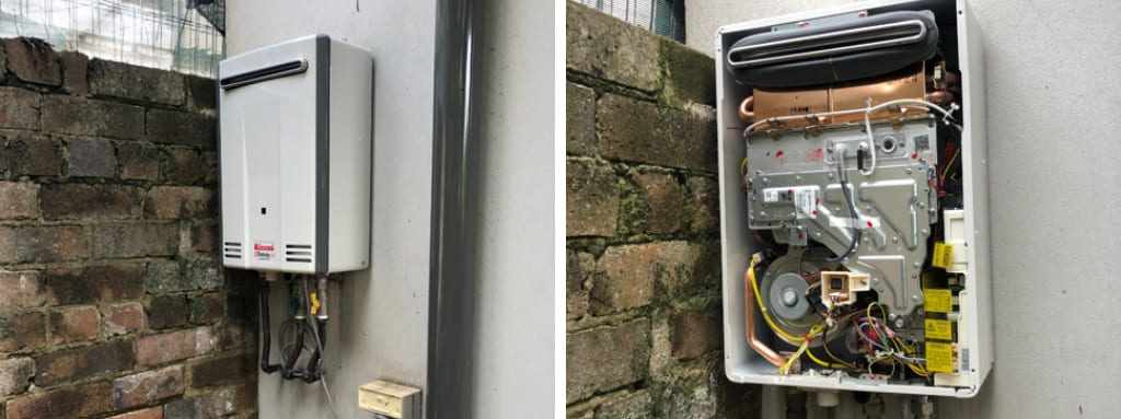 A hot water unit with the door open for inspection and fixing