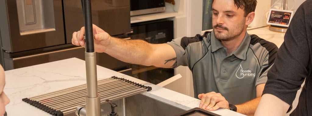 Rozelle Plumbing team member fixing a tap