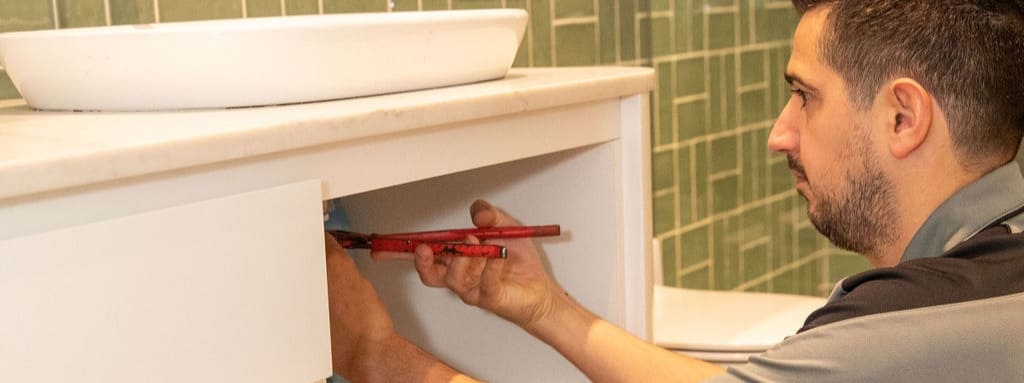 Rozelle Plumbing plumber fixing a leaking sink